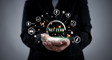 businessman holds a glowing 'Net Zero' concept with sustainability icons, symbolizing carbon neutrality, green energy, eco-friendly solutions, and environmental responsibility in modern business