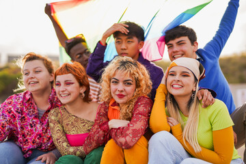 Fototapeta premium Young multiracial people celebrating together LGBT gay pride party - Diverse teenager with rainbow flag outdoor
