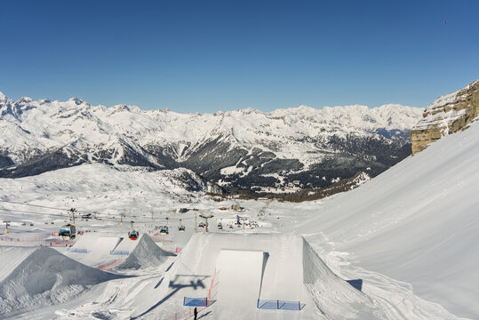 Big kicker in snowpark. Snow covered jump ramp, kicker in a winter landscape with soft lighting and smooth textures.  Madonna di Campiglio ursus snowpark in Val Rendena dolomites trentino Italy..