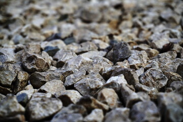 Close-up light beige and white small stones, gravel rugged background Texture. the irregularly shaped, light colored stones
