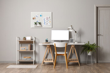 Interior of modern office with workplace and pegboard