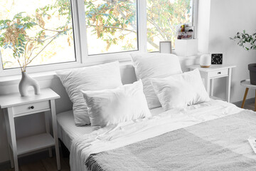 Interior of hotel room with big bed and tables