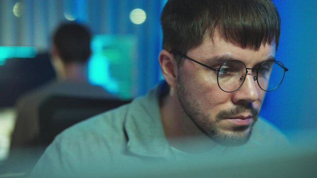 Developer engrossed in coding under the moonlight, epitomizing quiet nights filled with creativity and problem-solving.
