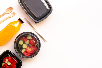 Tomatoes salad in plastic delivery tray, top view. Catering concept