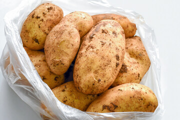 Raw potatoes in a plastic bag.