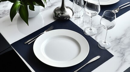 Elegant restaurant table setting with white plates, silverware, and wine glasses on a navy blue placemat, complemented by a modern lamp and decorative plant for a refined dining ambiance.