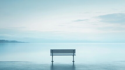 Tranquil Seascape with Empty Bench at Calm Shore Under Soft Blue Sky and Gentle Water Reflections for Serene Moments