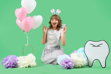 Tooth Fairy with plastic figure and balloons on green background