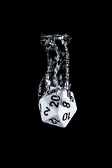 Splash photography of a 20 faces dice dropped in water with black background
