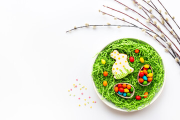 Easter dinner table setting with bunny cookie, top view. Happy Easter concept