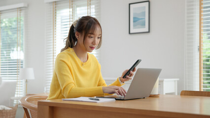 Young woman AI talent workforce help ask job career plan. Adult female asia people happy smile sit digital nomad work at home typing asking ChatGPT chat bot mobile phone buy paying online chatbot app.