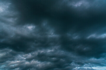 Dramatic dark storm thundercloud rain clouds on black sky background. Dark thunderstorm clouds rainny landscape. Meteorology danger windstorm disaster climate. Dark cloudscape storm disaster gray sky