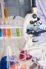 Vertical Horizon Science laboratory chemistry test science lab with microscope glass tubes on white table scientific background. Vertical Colorful Liquid biology scientist laboratory chemical fluid