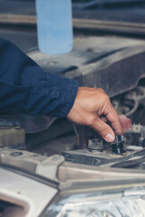 Vertical Mechanic man hands repairing car shop. Man hands fixing Car machinery vehicle mechanical service. Vertical horizon vehicle hood checking automobile. Car motor Workshop oil garage maintenance