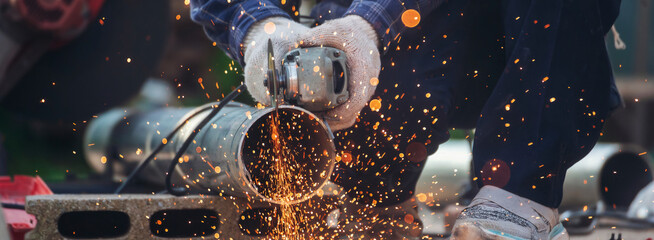 Banner Men hands wear protective glove Hot flame metal work cut fire iron workshop. Locksmith cut...