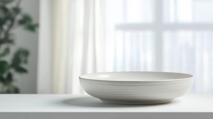 White Ceramic Bowl On A White Surface In Front Of A Sheer White Curtain With Daylight