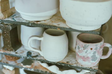 clay mugs in kiln for firing pottery