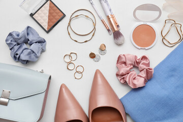 Composition with cosmetics, accessories, hair elastic and earrings on white background. Closeup