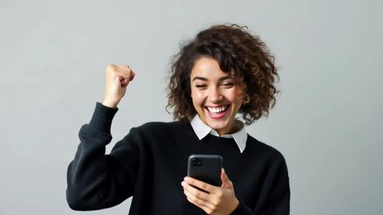 Overjoyed Woman Celebrating Success with Mobile Phone