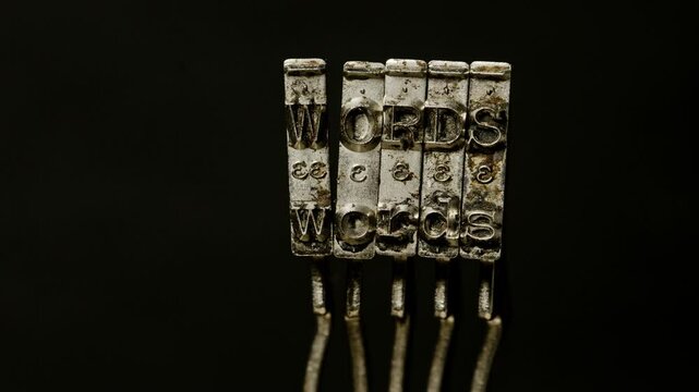 Macro of old typewriter hammers with the word WORDS 