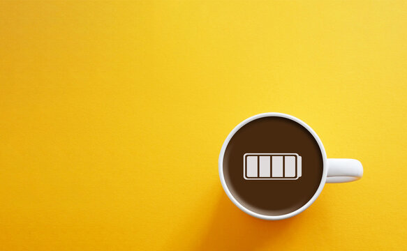 A cup of coffee with icon of a charged battery as boost of energy for the productive day. Every day is a fresh start