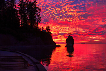 West Coast Dramatic Sunset. Sunset over the sea. Siwash Rock. Stanley Park, Vancouver, British Columbia, Canada