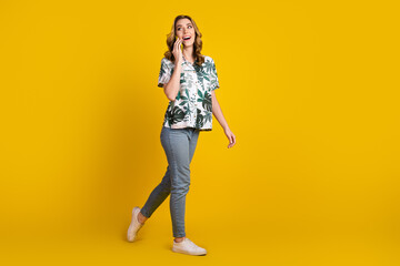 Attractive Young Woman in Casual Stylish Outfit Enjoying a Moment Against a Bright Yellow Background, Showcasing Happiness
