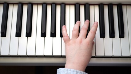 Children's hands on piano keys