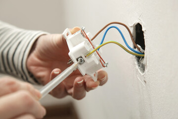 Electrical Outlet Repairing and Assembling - home improvement concepts. Master electrician installs...