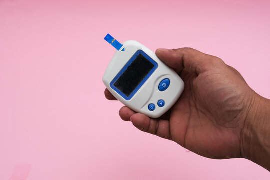 World Diabetes day concept ,14 November. Top view of blood glucose meter sets on isolated pink background.