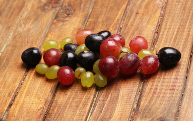 set of bunches of grapes on wooden background