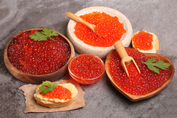 set of bowls and sandwiches with red caviar