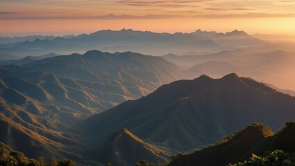 Sunrise Over Rolling Mountain Ranges in Misty Landscape