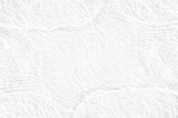 White water with ripples on the surface. Defocus blurred transparent white colored clear calm water surface texture with splashes and bubbles. Water waves with shining pattern texture background.