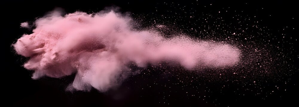 A fine puff of delicate pink blush powder dispersing into the air on an isolate background