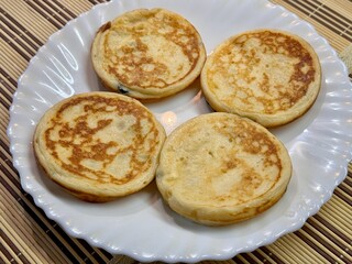 A Stack of Delicious Pancakes Presented on a Bright White Plate for Your Enjoyment. These fluffy pancakes are absolutely perfect for enjoying breakfast, beautifully served on a classic white plate