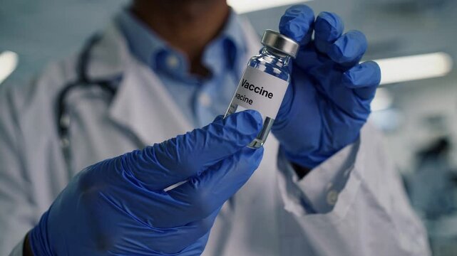Vaccine Vial in Medical Professional's Hands: A close-up shot of a doctor holding a vaccine vial, representing healthcare, vaccination, and medical progress