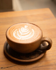 Cappuccino decorated with an artistic motif made with milk foam.