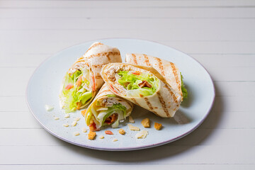 Turkey wraps on a plate. Tortilla, burritos, sandwiches, twisted rolls