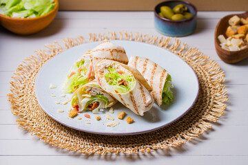 Turkey wraps on a plate. Tortilla, burritos, sandwiches, twisted rolls