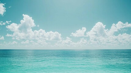 Obraz premium Tranquil ocean view, placid sea, fluffy clouds, azure sky