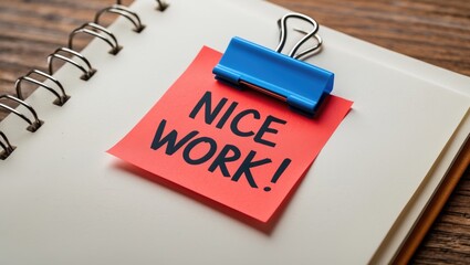 Document featuring a red note with the handwritten message NICE WORK, representing the concept of providing positive feedback and praise for a job well done, a compliment from a boss or client to s...
