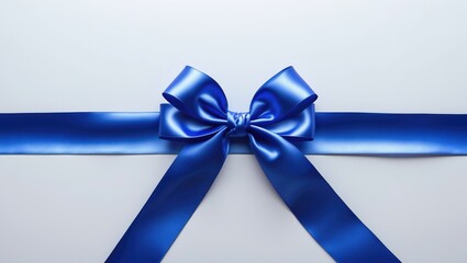 Satin ribbon in blue with bow on a white background, viewed from above.