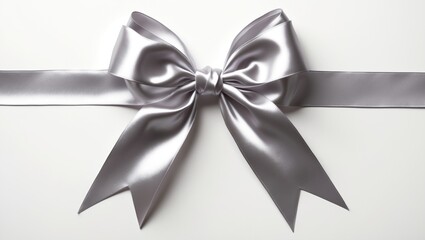 Beautiful silver ribbon arranged in a bow, isolated on white, viewed from above.