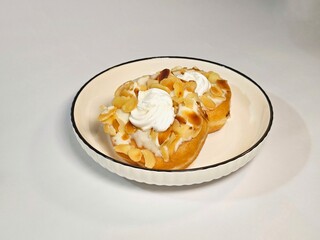 Donuts with Almond and Cream topping that put on the plate