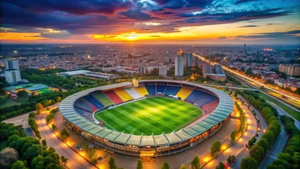 Papier peint photo  Aerial View of Stadium at Sunset Over Urban Landscape  © Naowarat