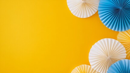 Blue and White Paper Fans on Yellow Background