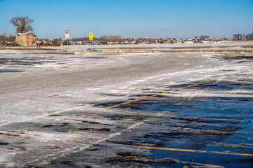 Snow covered parking lot with the lines covered in some locations. © Lost_in_the_Midwest
