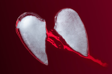 Broken Ice Heart in a Two Half Pieces on Dark Red  Background. The two halves of the love symbol...