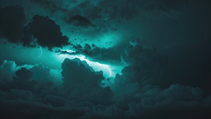 Fototapeta premium Dramatic night sky in dark greenish blue. Background of gloomy storm rain clouds. Thunderstorm hurricane wind lightning creating an epic fantasy or spooky nightmare horror concept.